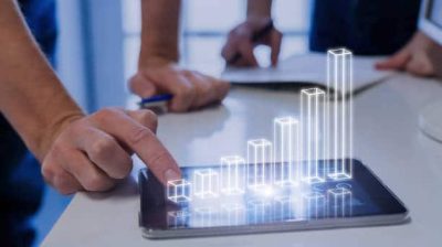 Team of business people analyzing 3D augmented reality chart above digital tablet computer screen showing growing results and investment success, technology